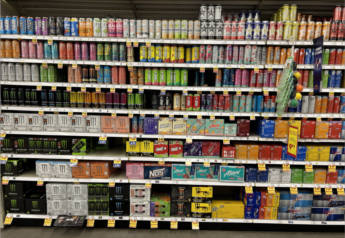 Photo of a 10 foot tall shelf at a grocery store, filled top to bottom with energy drinks.